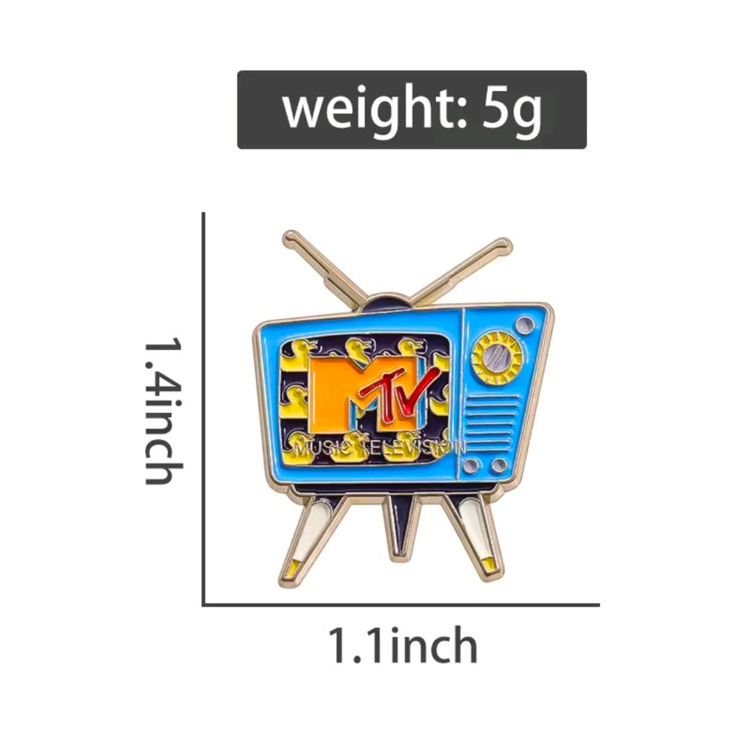 Retro TV enamel pin with MTV logo, blue screen, yellow graphics, and gold antenna posts