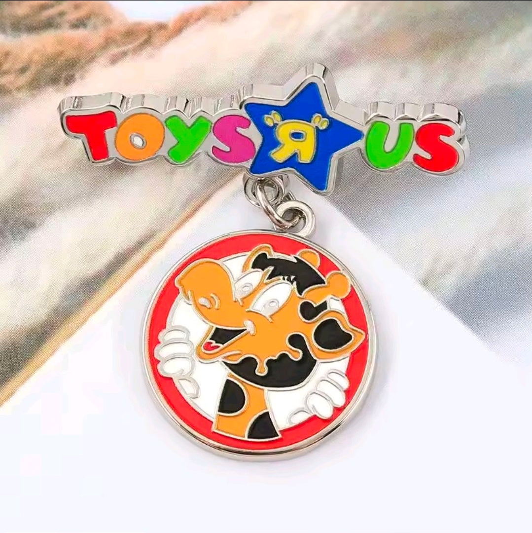 Enamel dangle charm pin with Toys R Us star and giraffe medallion