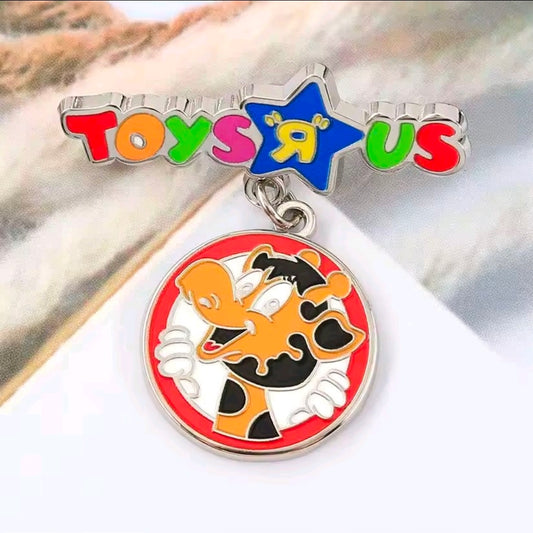 Enamel dangle charm pin with Toys R Us star and giraffe medallion