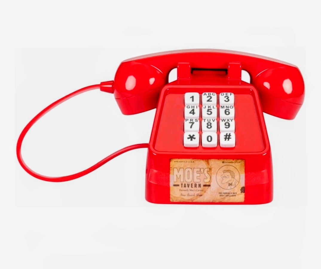 Red prank phone with detached handset and number keypad, Moe’s Tavern label
