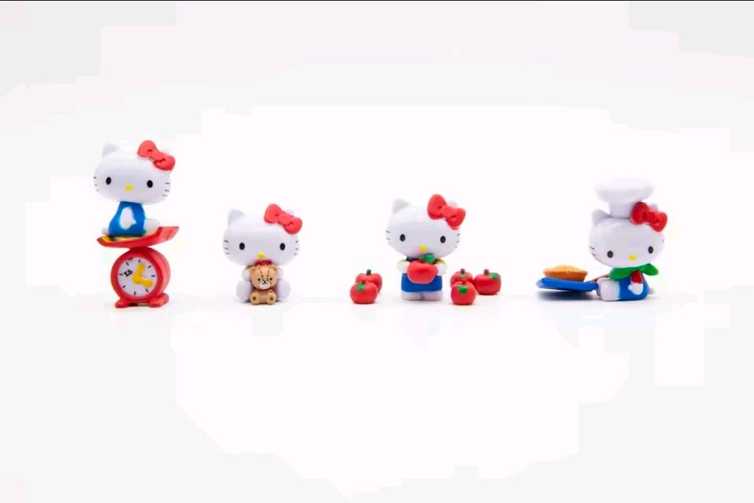 Hello Kitty mini figure set of 4 with red bow and accessories arranged together