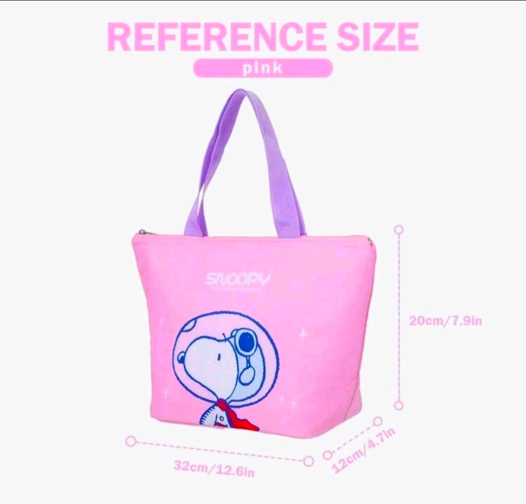 Pink insulated lunch bag with blue Snoopy graphic and purple handle straps; size reference