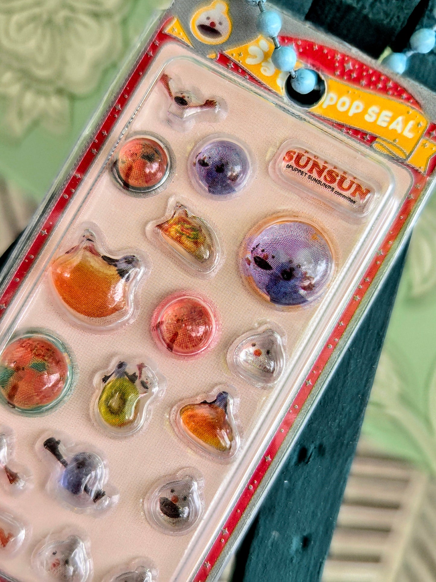 Clear blister sticker keychain pack with colorful animal icons and beaded loop