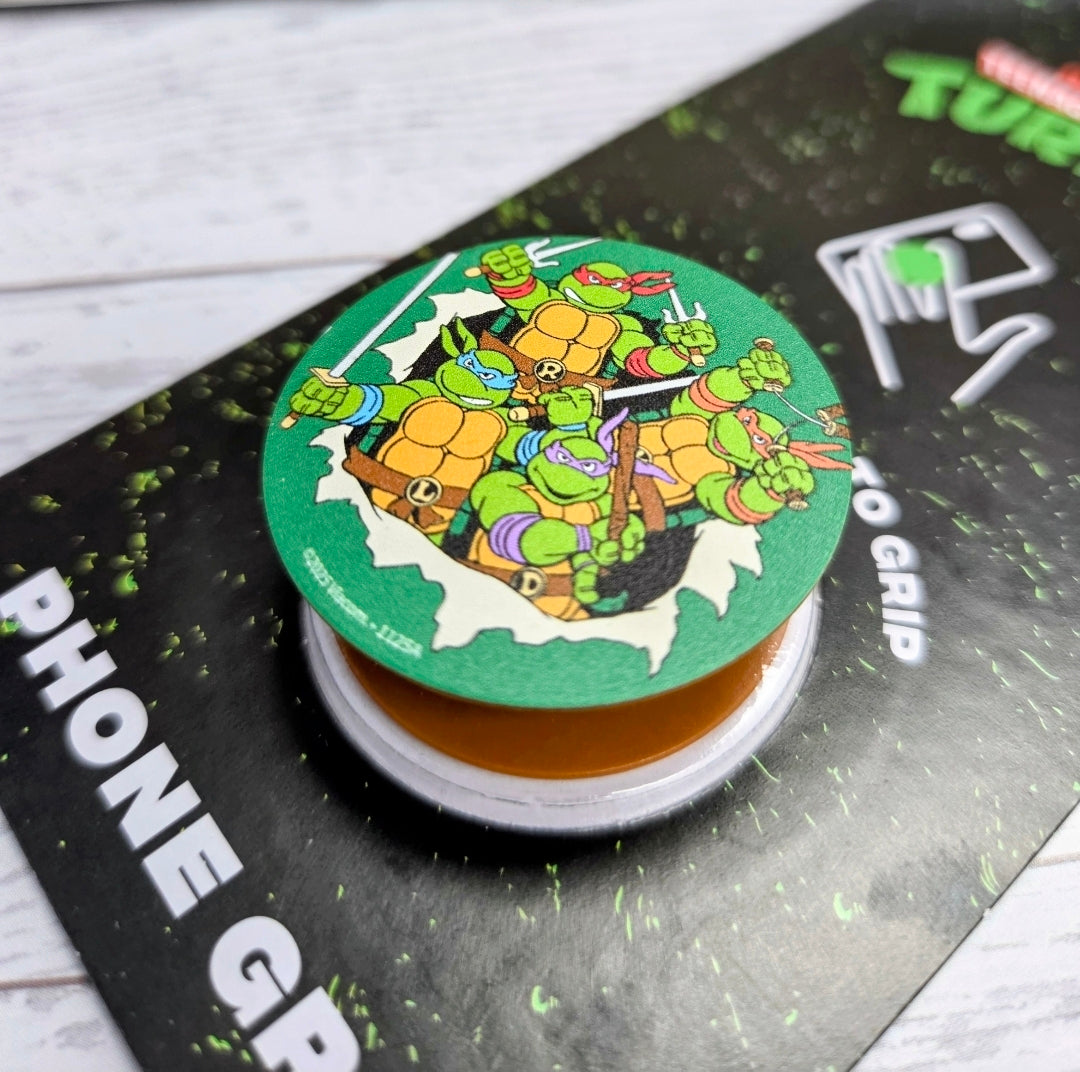 TMNT phone grip holder round pad with Turtles character artwork