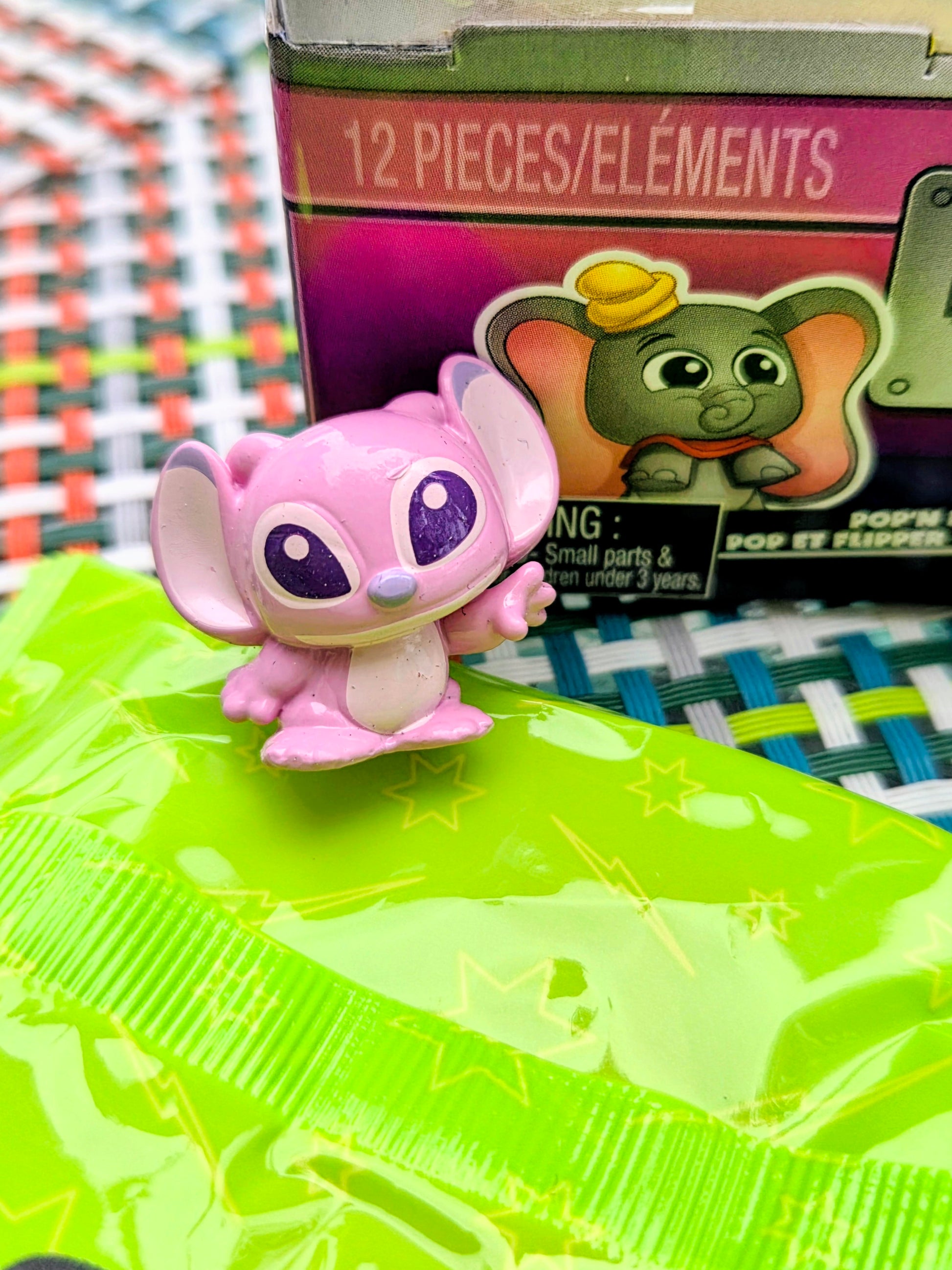 Pink Squish'alots figure on neon green Pop N' Pinball mat in front of the box