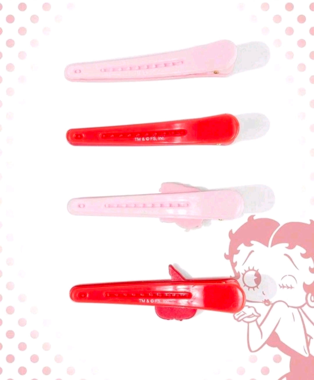 Side view of pink and red snap hair clips with secure hinge