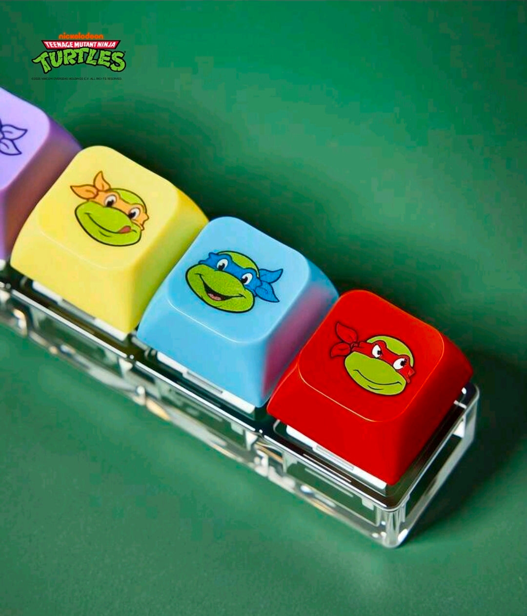 TMNT keyboard clicker keychain with four colored turtle keycaps and metal base