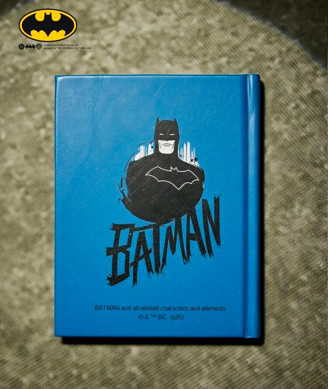 Blue hardcover journal notebook with large Batman emblem graphic on cover