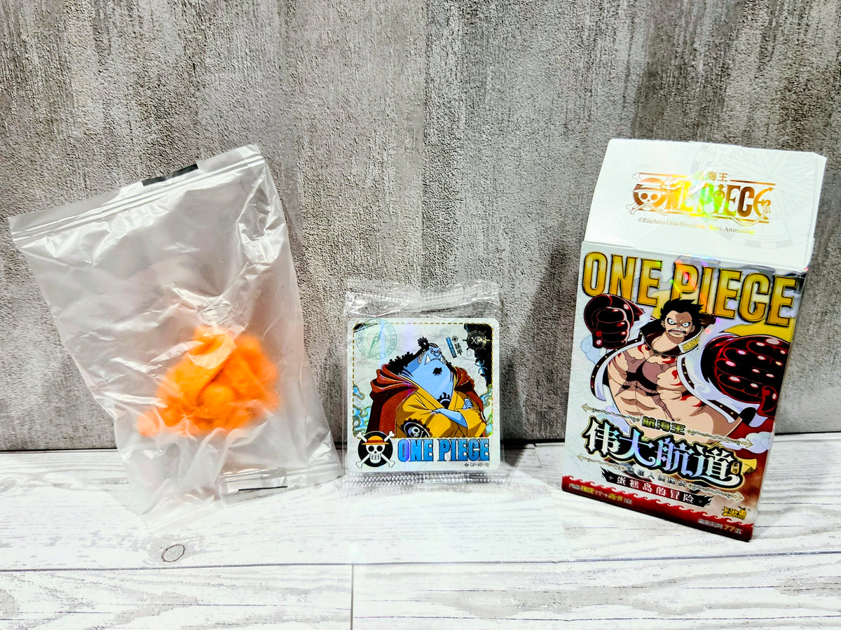 Sealed bag with small orange collectible figure with One Piece character card and box
