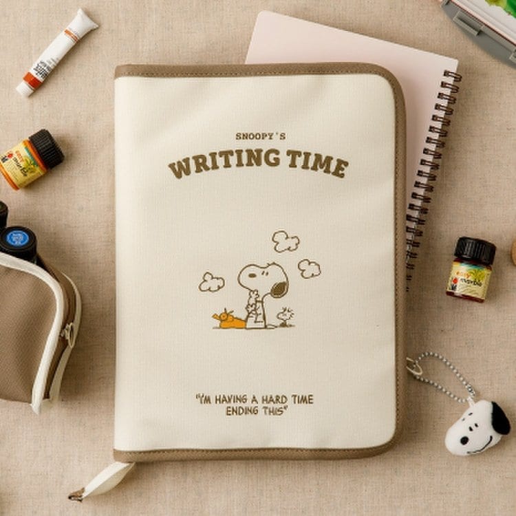 Beige writing time portfolio organizer with Snoopy illustration and brown edge binding