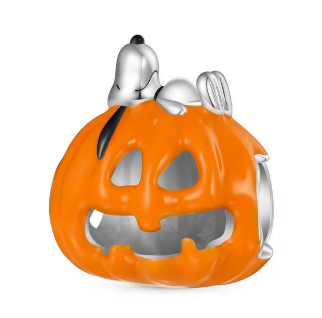 Silver charm with orange jack-o'-lantern enamel and small sleeping dog figure on top