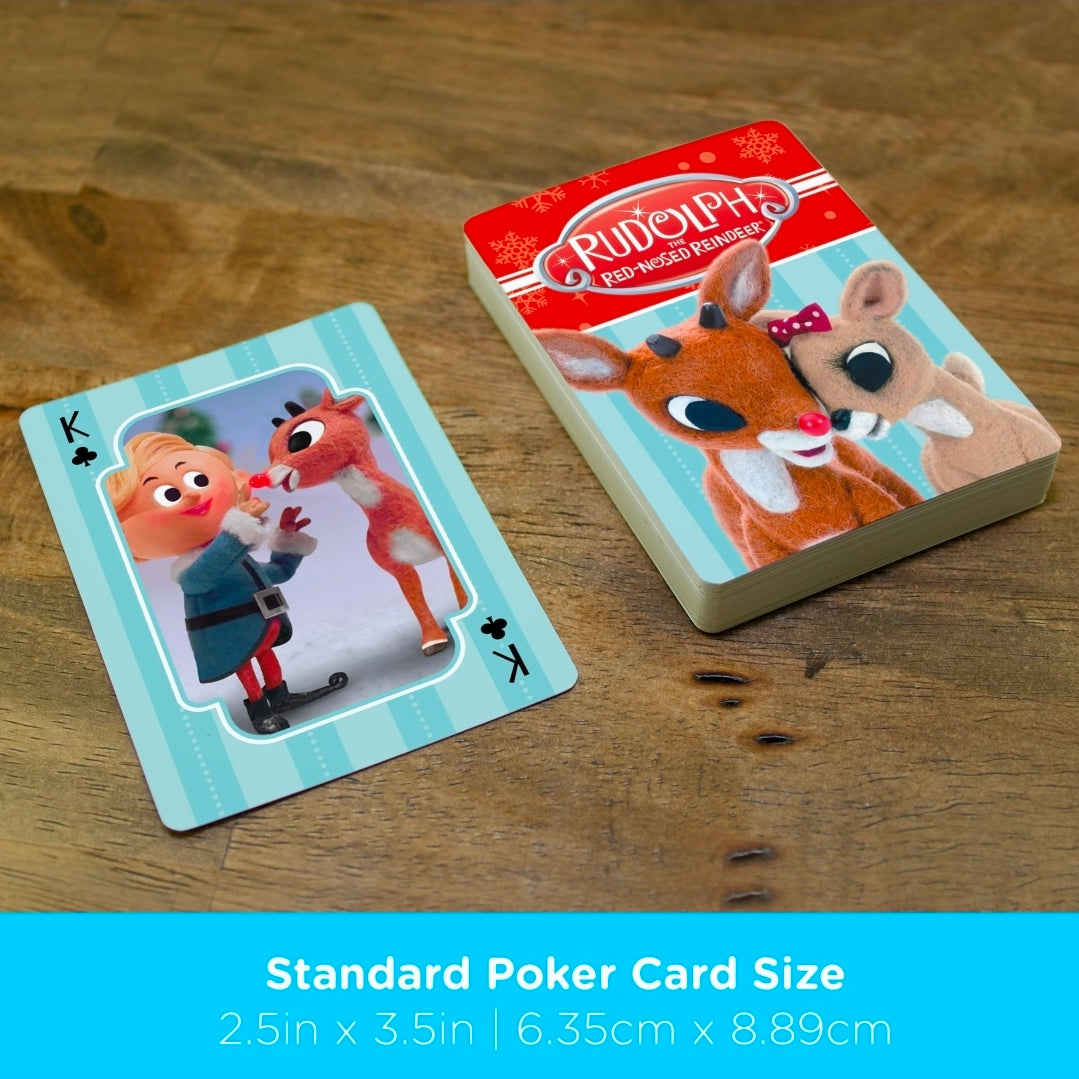 Rudolph reindeer playing cards and card stack on wooden surface