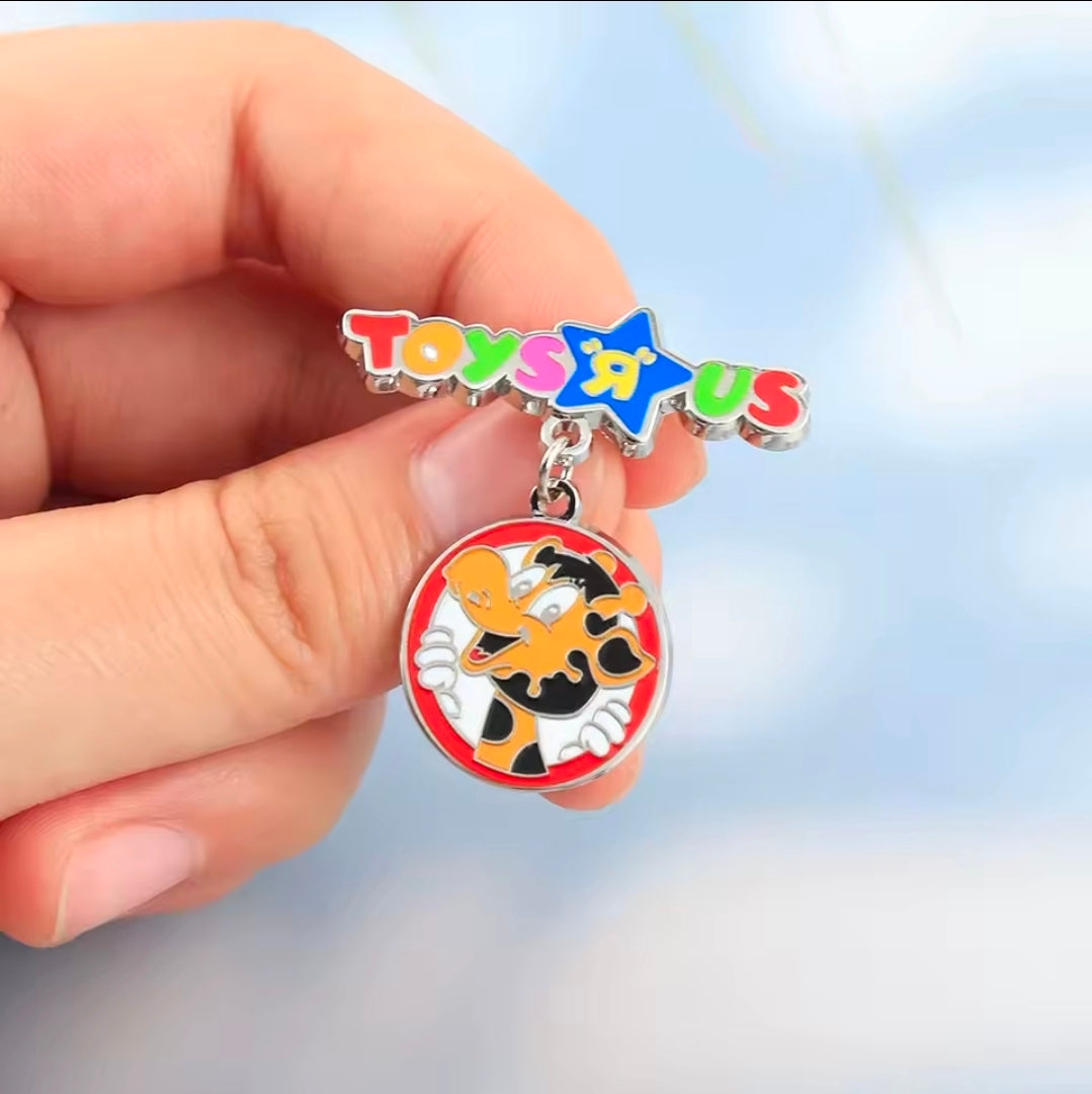 Multicolor enamel Toys R Us star pin with dangle giraffe charm