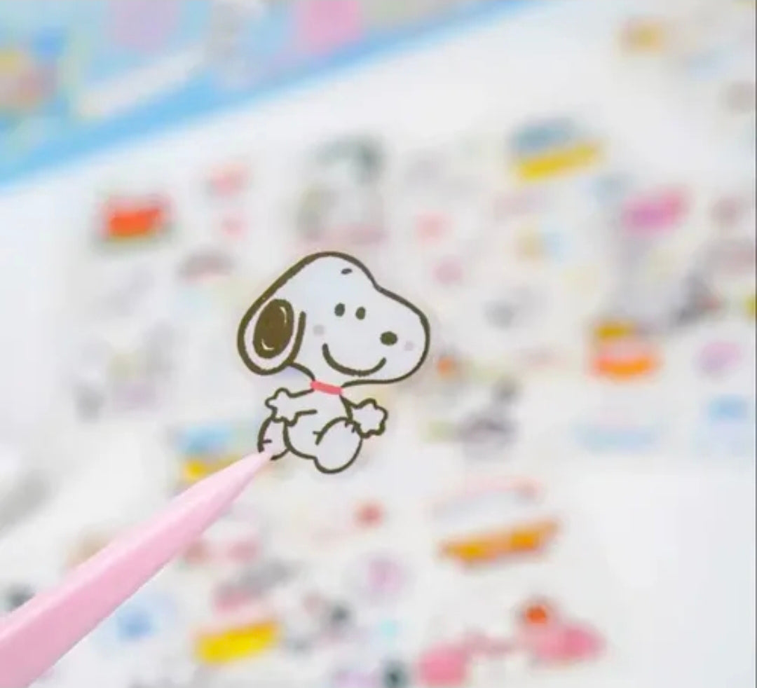 Close-up of a Snoopy line-art sticker on a colorful background sheet