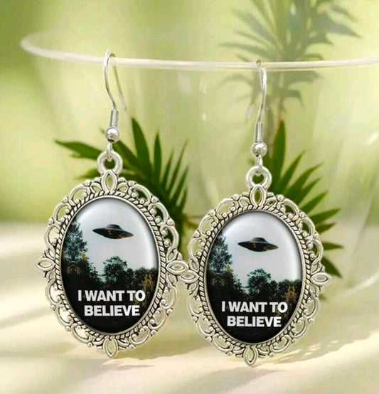 Silver oval dangle earrings with UFO art and I Want to Believe lettering in oval bezels