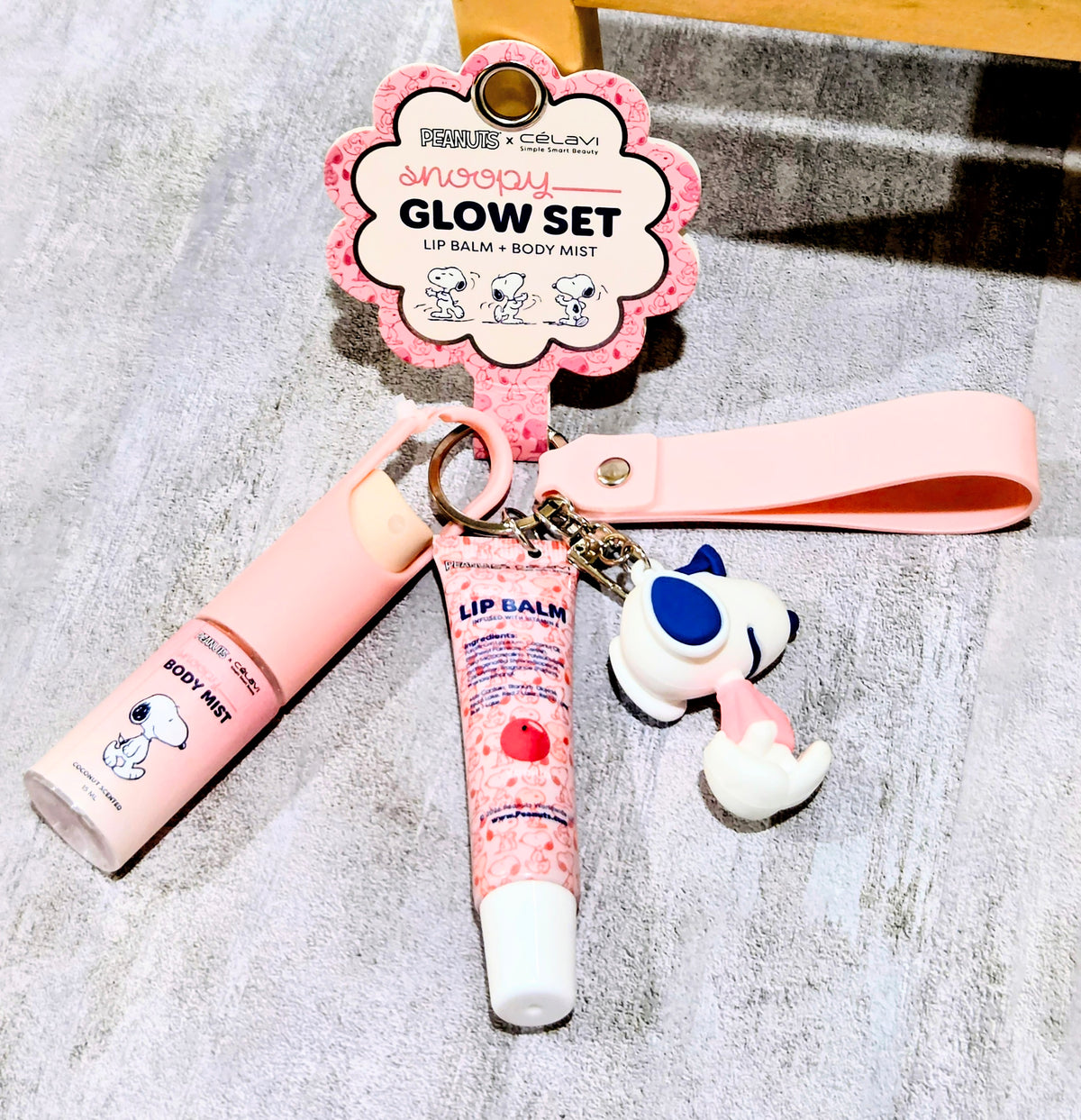 Glow set keychain with Snoopy figure, pink lip balm tube, and body mist bottle