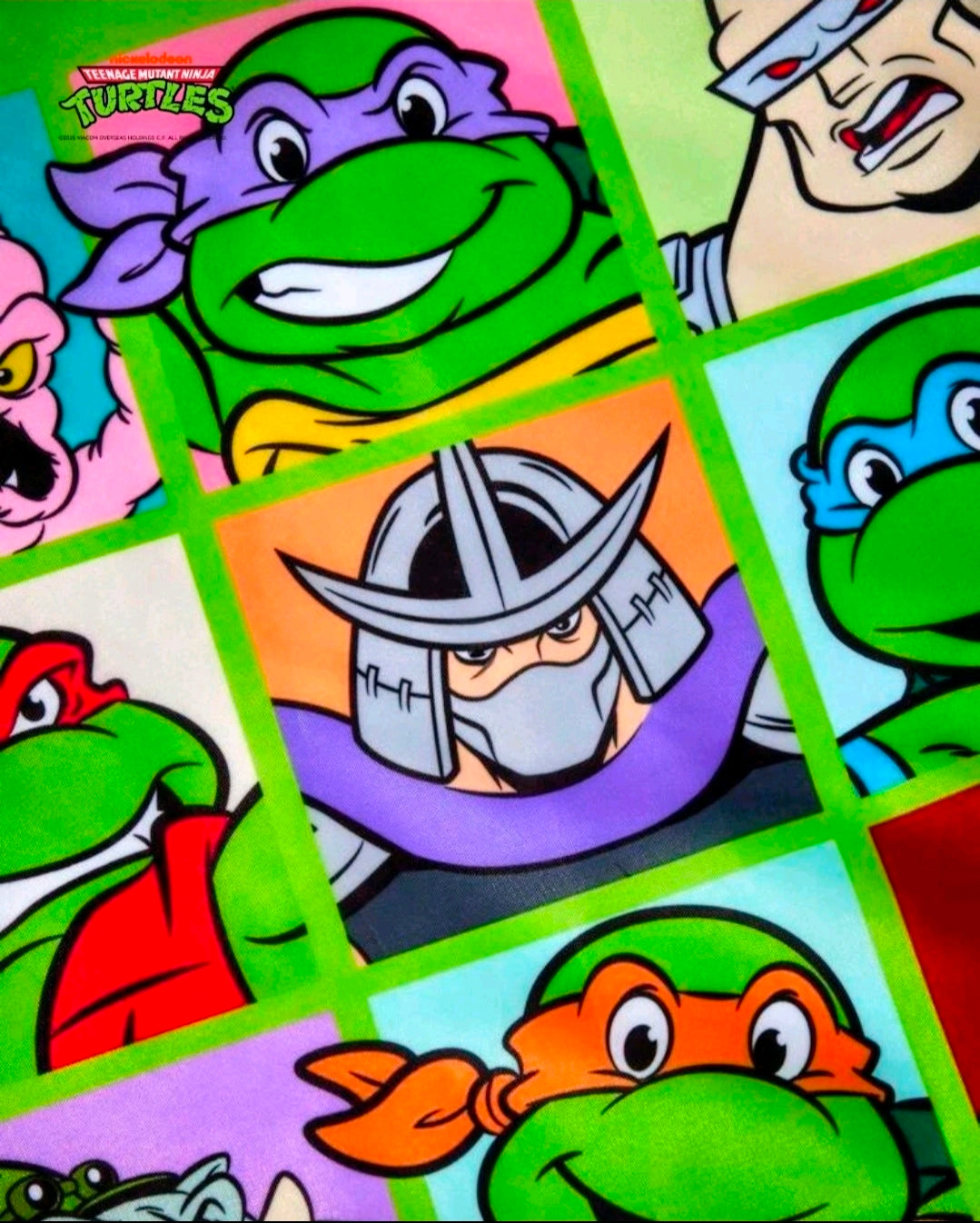 Green tote bag fabric with colorful character grid collage artwork