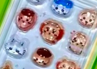 Mini gashapon sticker keychain close-up of round 3D character stickers in clear blister