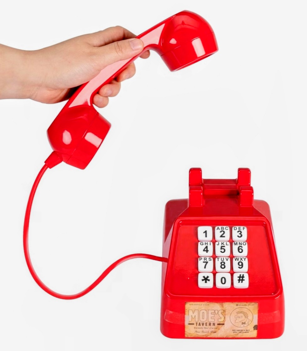 Red life-size prank phone with handset and number keypad with Moe’s logo and audio cues
