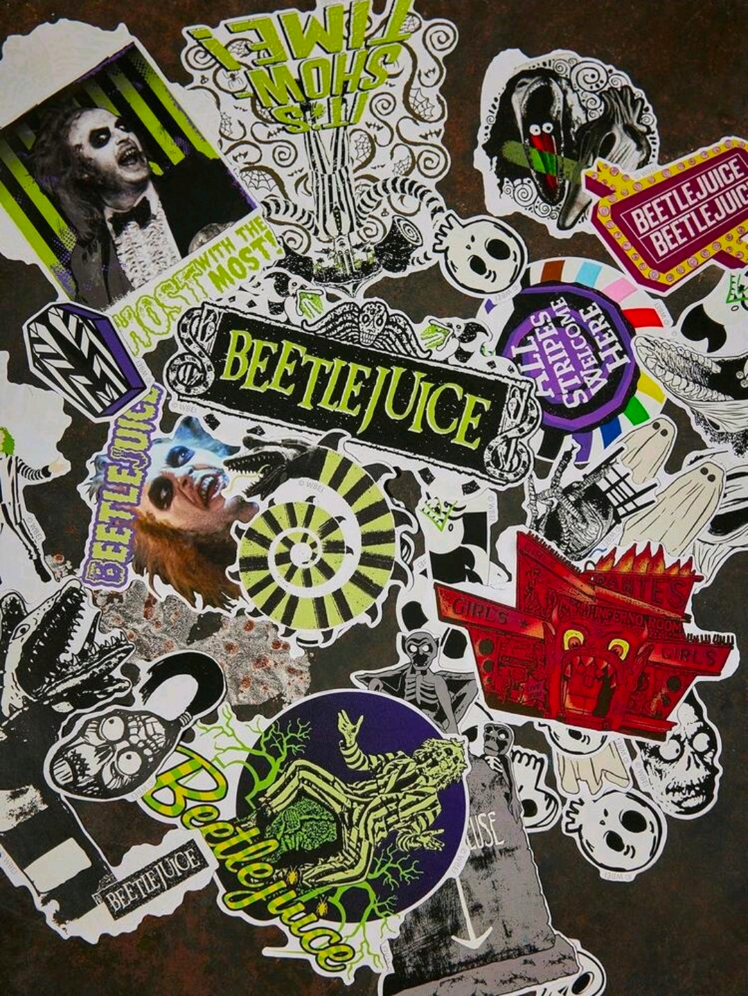 Assorted Beetlejuice glow-in-the-dark stickers with ghost, patterns, and skulls