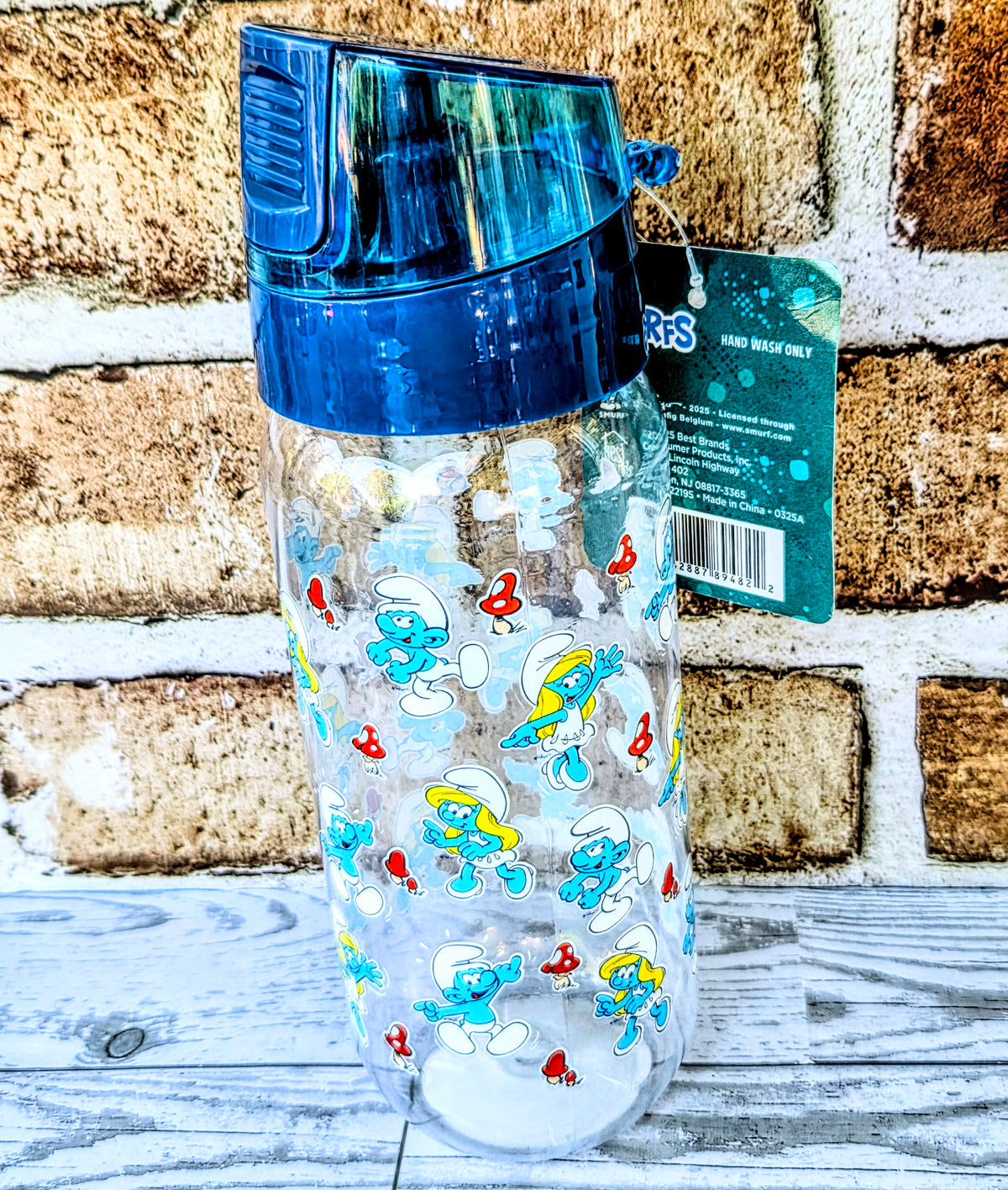 Blue Smurfs character water bottle with teal info card behind