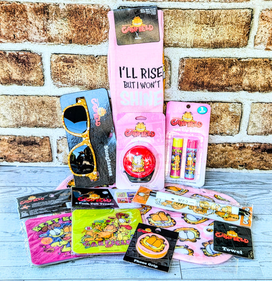 Garfield self-care gift set featuring pink crew socks with bold 'I'll Rise' text and accessories.