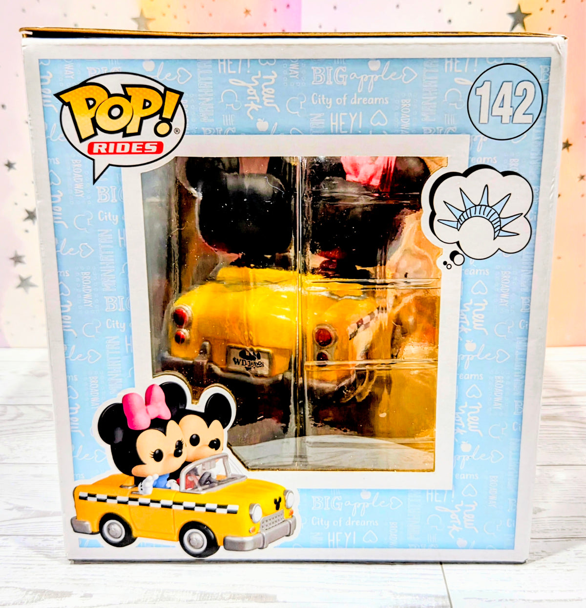 Funko Pop Rides #142 boxed Mickey Mouse and Minnie Mouse riding yellow taxi