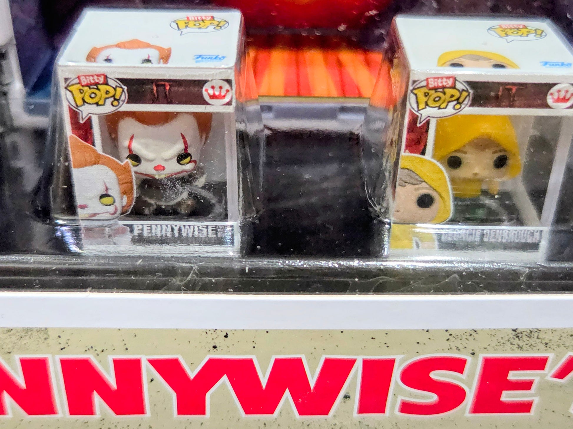 Blister pack showing Bitty Pop! mini figures: orange clown and yellow-faced character