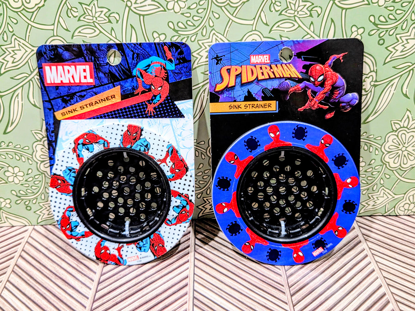 Spider-Man sink strainer set with two black discs and blue web patterns
