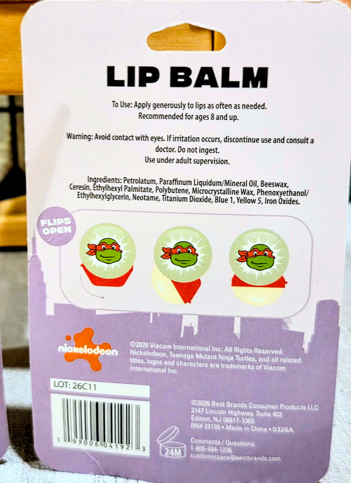 Lip balm package front with warning text and three opening icons