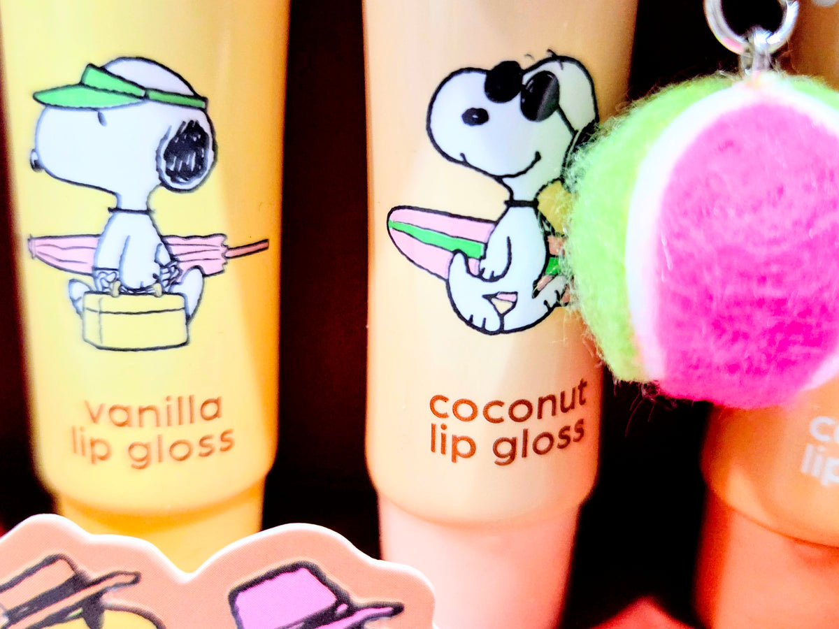 Sun kissed lip gloss tubes with Snoopy labels, plus green pom-pom charm