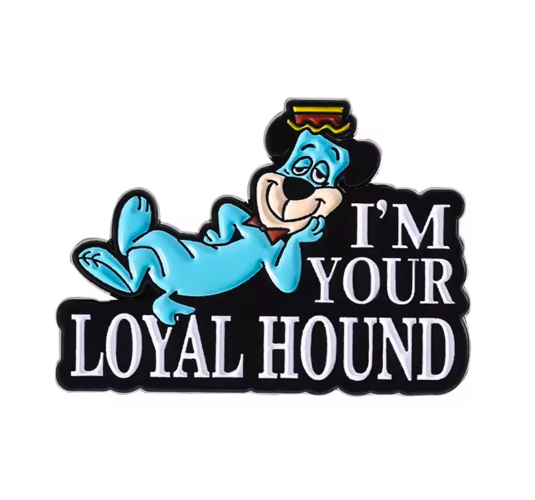 Enamel pin reading I’m Your Loyal Hound with blue character and hat