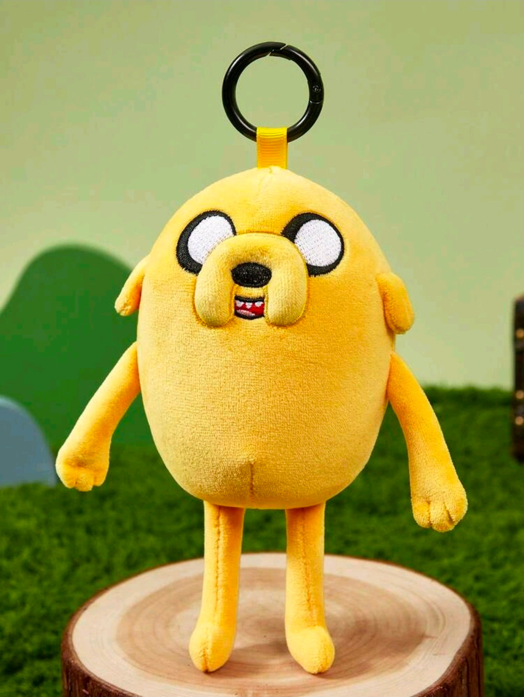 Yellow Jake the Dog plush bag charm keychain, close front with black keyring loop.