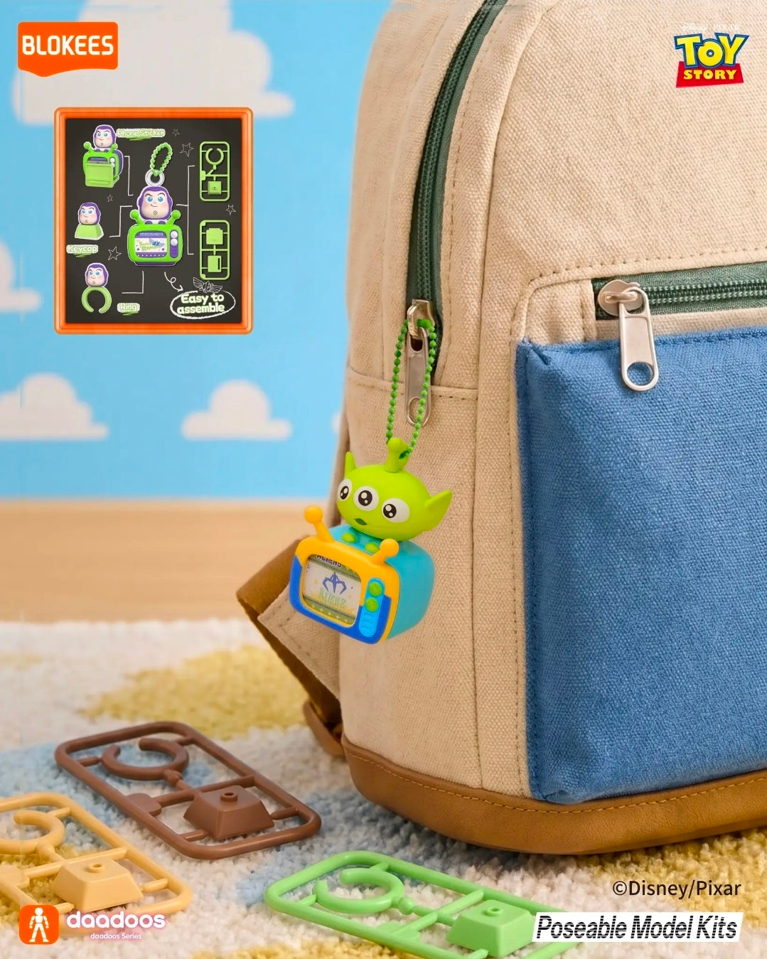 Green Alien TV figure keychain hanging from a backpack zipper