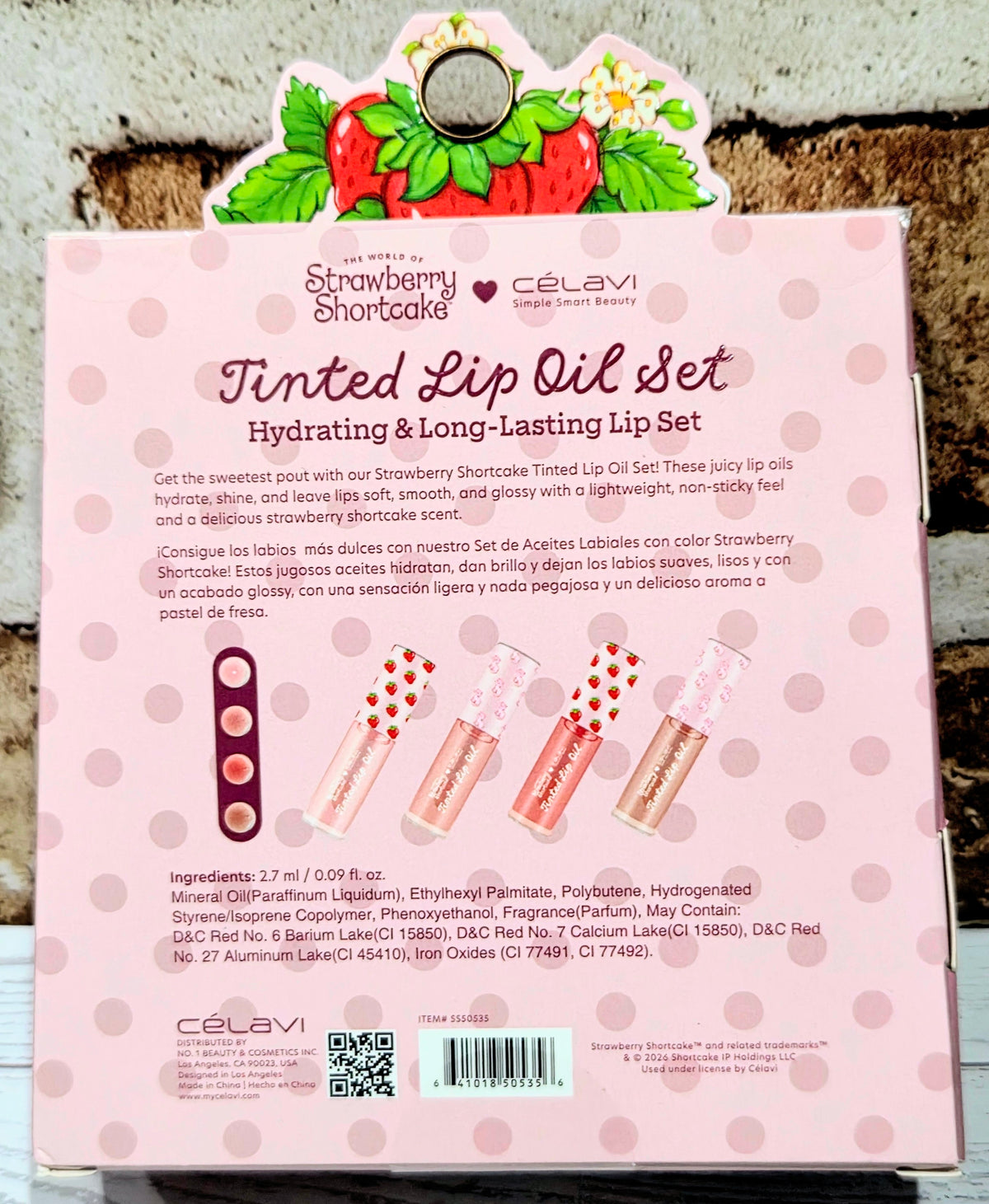 Tinted lip oil gift set box with four lip oil bottles, Strawberry Shortcake x Celavi branding.
