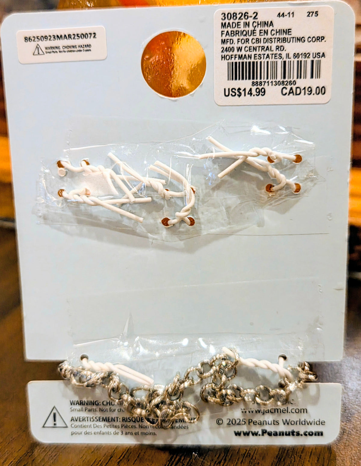 Two-charm set in clear plastic with gold-tone Snoopy-style dangles