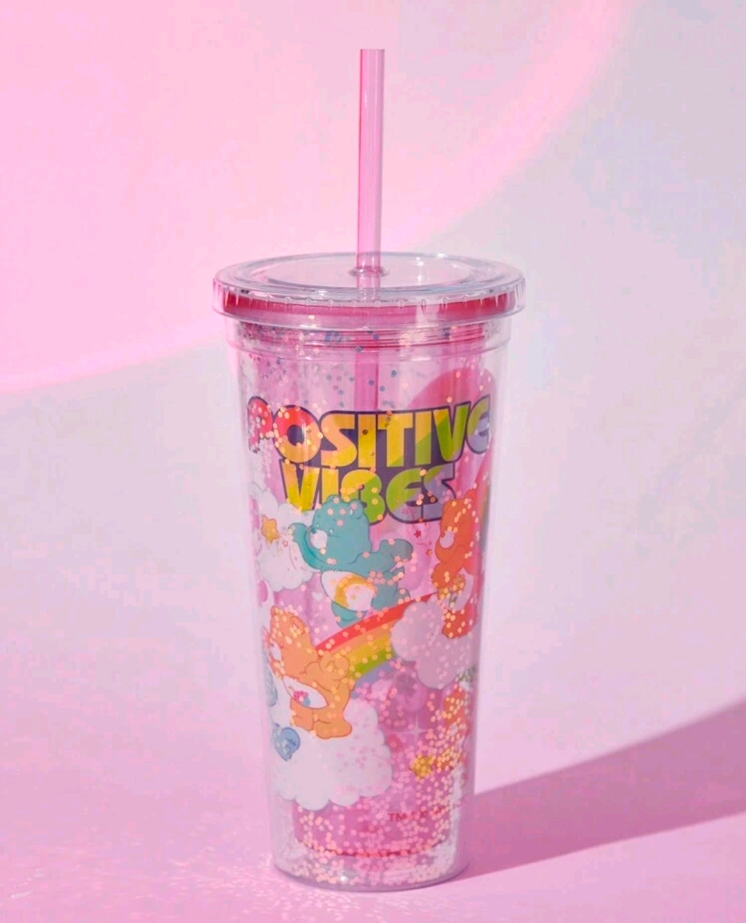 Glitter tumbler cup with straw, Care Bears positive vibes colorful characters.