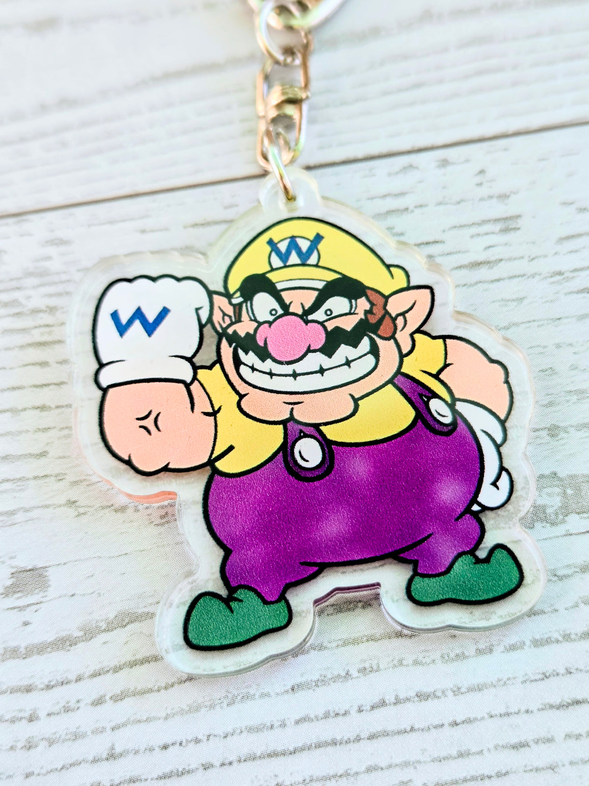 Acrylic keychain featuring Wario in purple with white chef hat and mustache