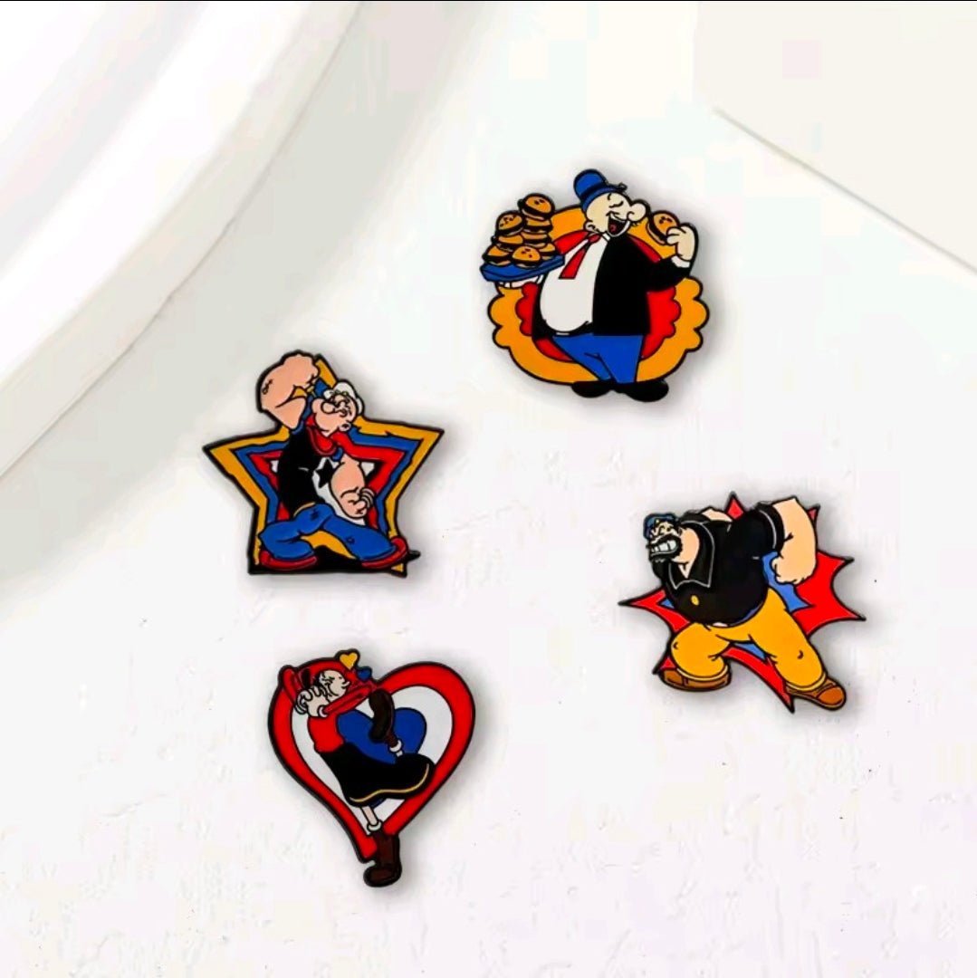 Four cartoon enamel lapel pins on a white surface: Popeye, Brutus, Olive Oyl, Wimpy.