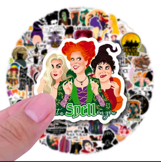 Large die-cut sticker of three witches in green with “Spell” lettering, surrounded by Hocus Pocus designs