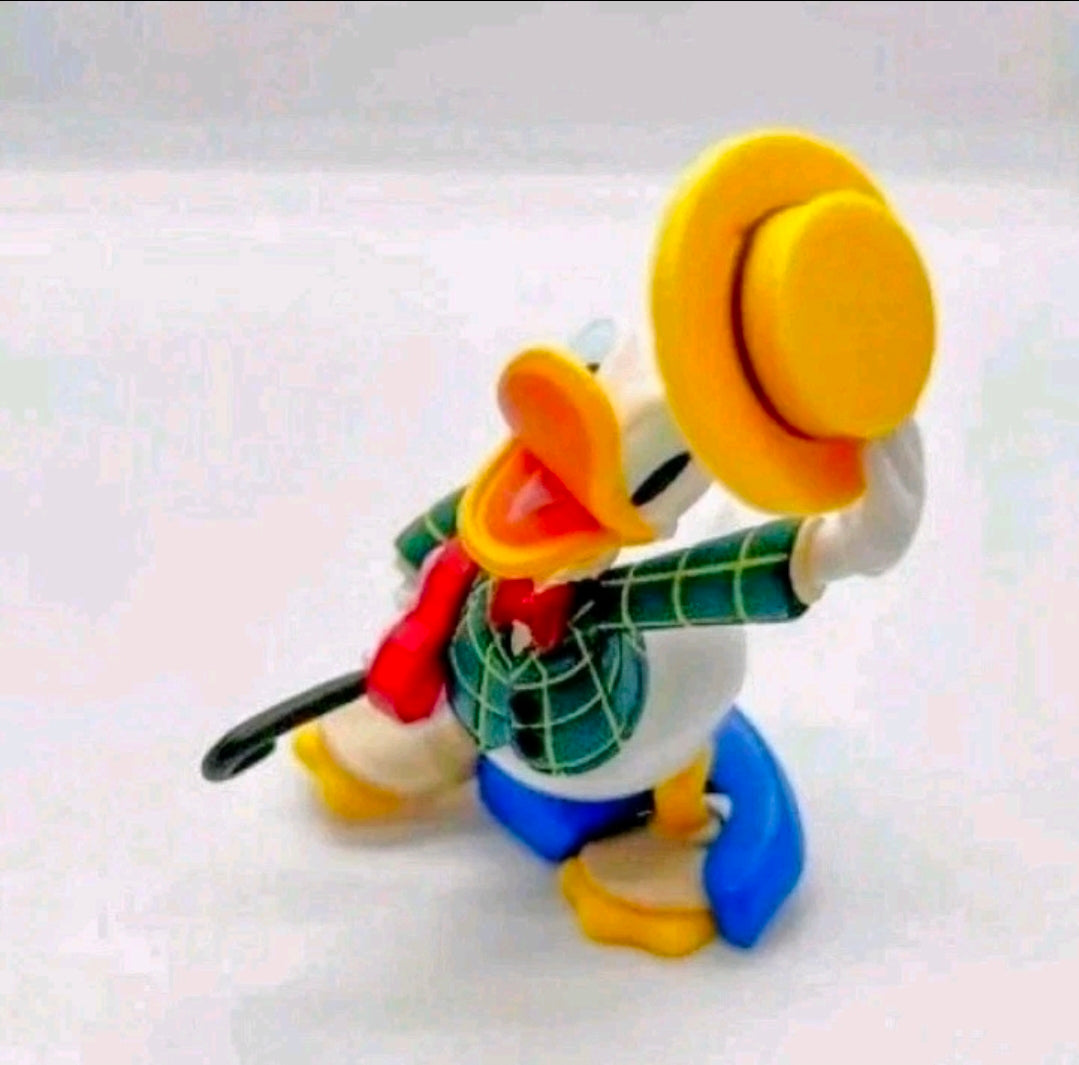 Donald Duck costume figure playing a green plaid guitar, red accent scarf, raised yellow hat