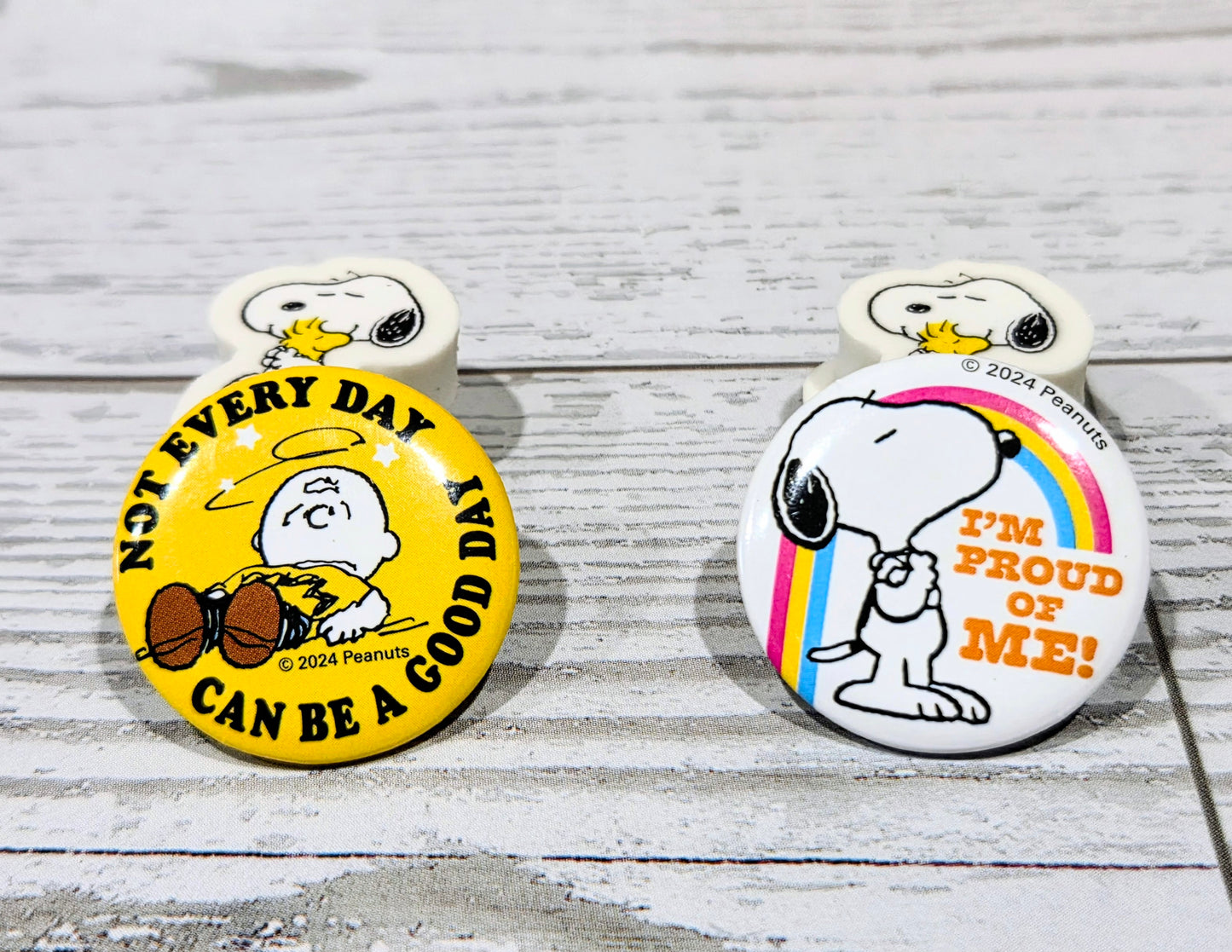 Two round Snoopy pin badges with text: “Not Every Day…” and “I’m Proud of Me”