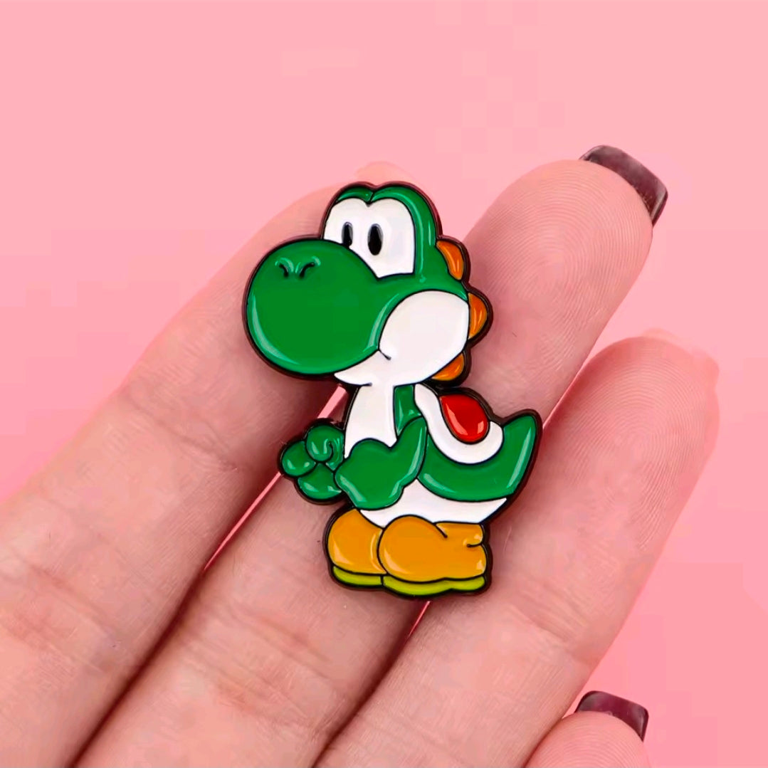 Yoshi enamel pin held between fingers, green character standing with white face