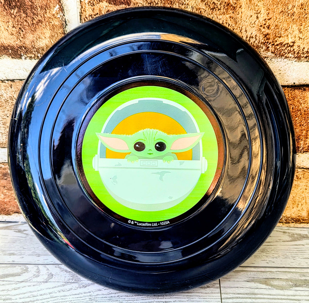 Dark blue pet bowl with centered Grogu face illustration in green and yellow