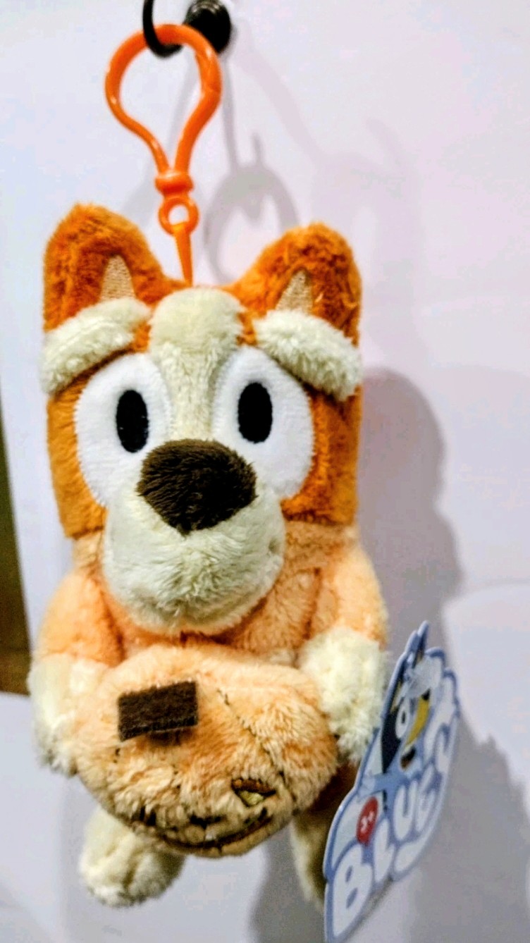Orange Halloween plush keychain with large ears and witch hat look, holding hanging tag