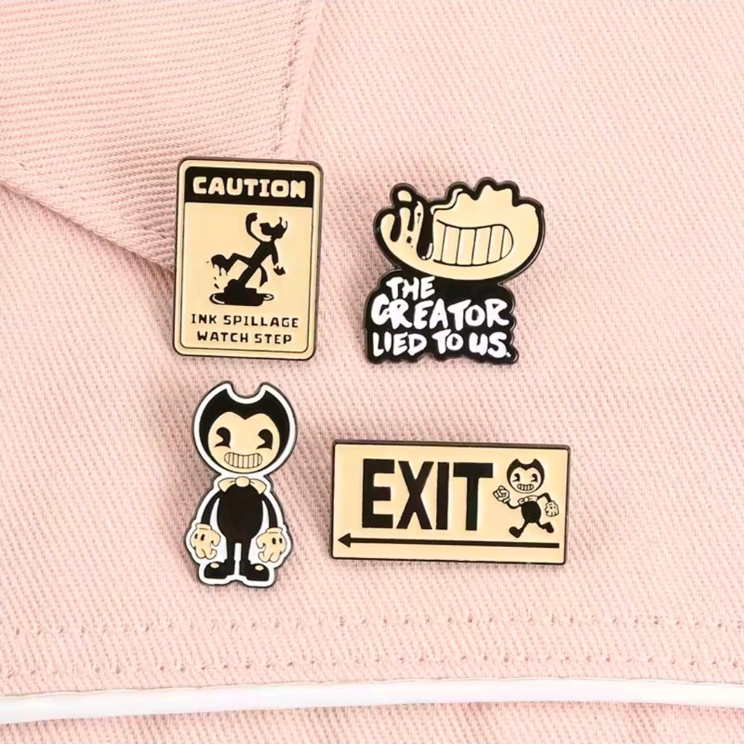 Four enamel pins on cloth: Caution, The Creator Lied to Us, hooded figure, EXIT