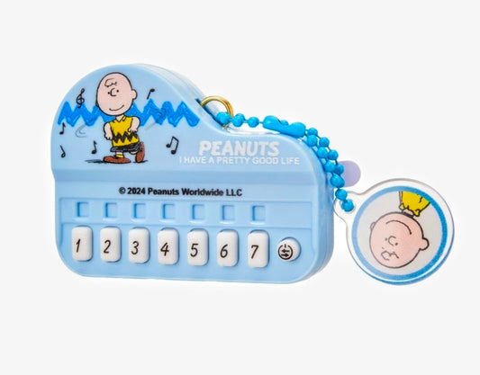 Mini electronic keyboard keychain with blue Peanuts theme and 1–7 playable keys