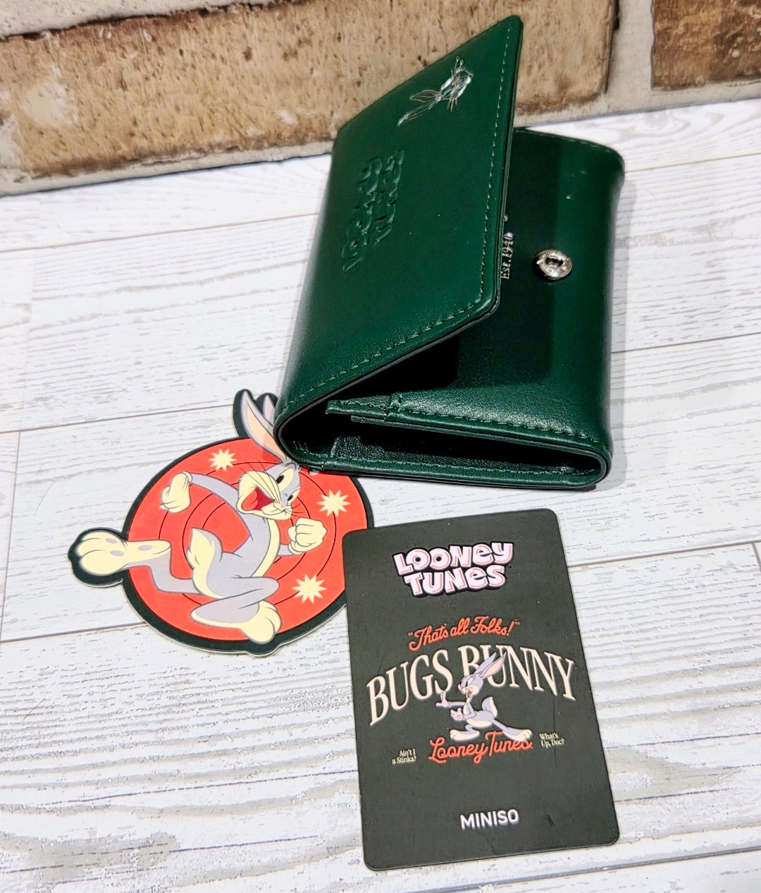 Green snap wallet open view with interior slots and silver button