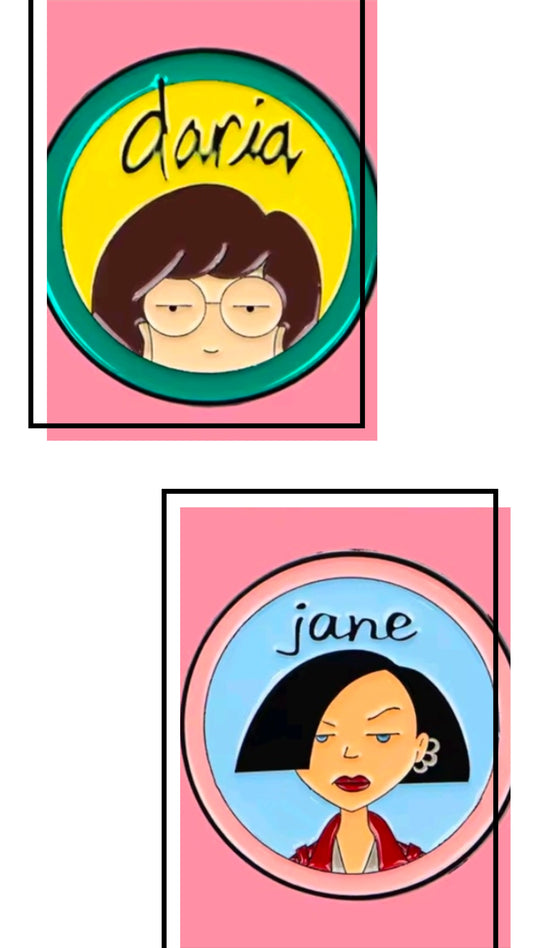 Two circle character enamel pins, Daria and Jane, shown side by side