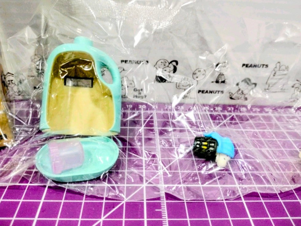 Toy detergent bottle housing with yellow panel and Snoopy character with blue basket